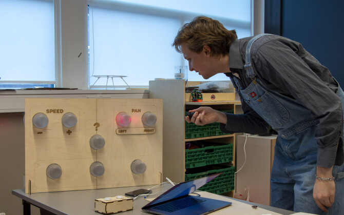 En av studentene på Arkitektur- og designhøgskolen demonstrerer en maskin han har laget som lar en styre musikk ved å peke på knapper med en laserpeker. 📸: Kurt Lekanger